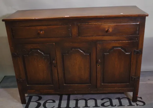 An early 20th century oak dresser base with two drawers over cupboard base, 122cm wide x 89cm high.