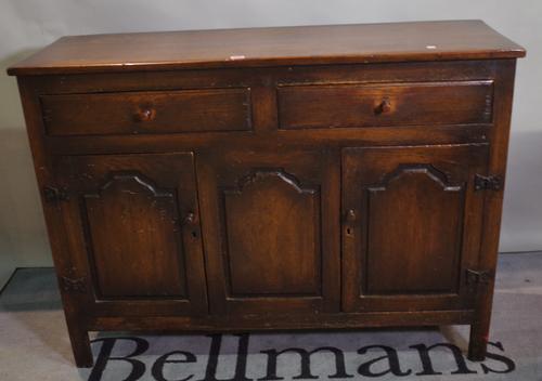 An early 20th century oak dresser base with two drawers over cupboard base, 122cm wide x 89cm high.