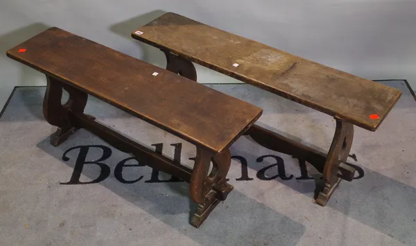 A pair of early 20th century oak benches on duel end supports, 105cm wide x 48cm high, (2).