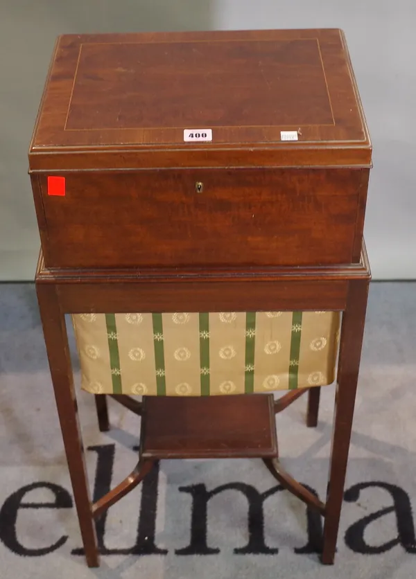 An Edwardian mahogany lift top sewing table with an undertier, 38cm wide x 81cm high.