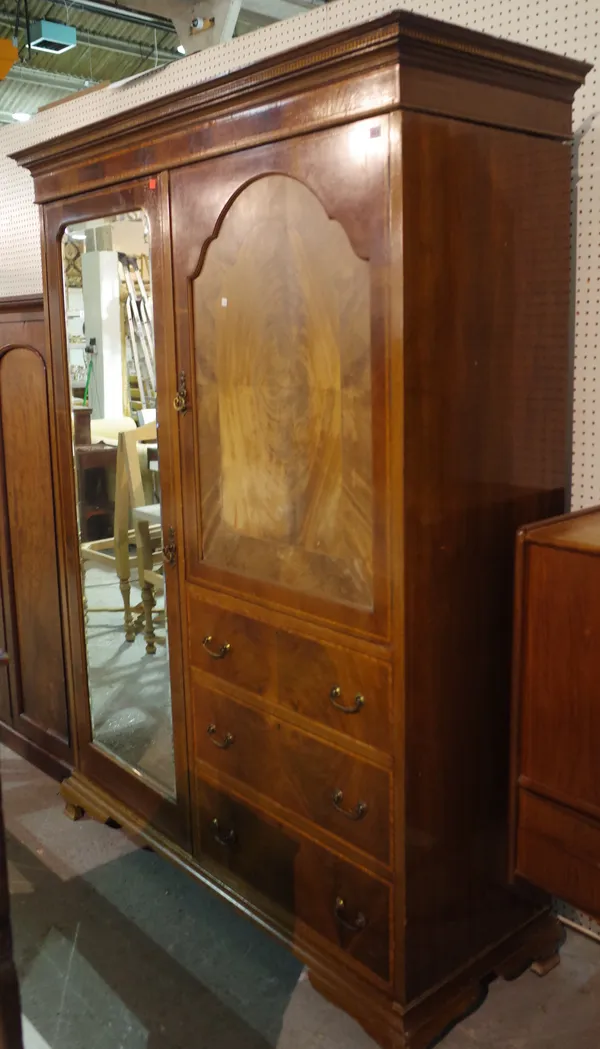 A Victorian walnut double wardrobe with arched mirrored door, 154cm wide x 195cm high.