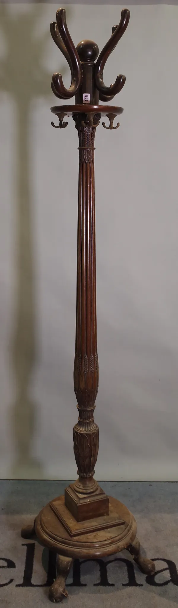 A Regency style mahogany coat stand with reeded column on circular plinth base and pad feet, 195cm high.