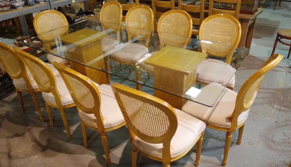 A 20th century oak and glass dining table with bevelled rectangular glass top on two oak pedestal base, 210cm long x 100cm wide and a set of ten Louis