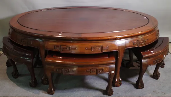 A 20th century Chinese hardwood oval low centre table 150cm wide x 51cm high with four matching pull out side table 55cm wide x 33cm high, (5).