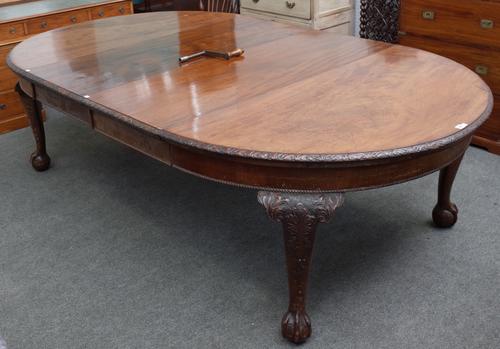 An early 20th century mahogany extending dining table on claw and ball feet, with two extra leaves, 144cm diameter x 252cm long extended.