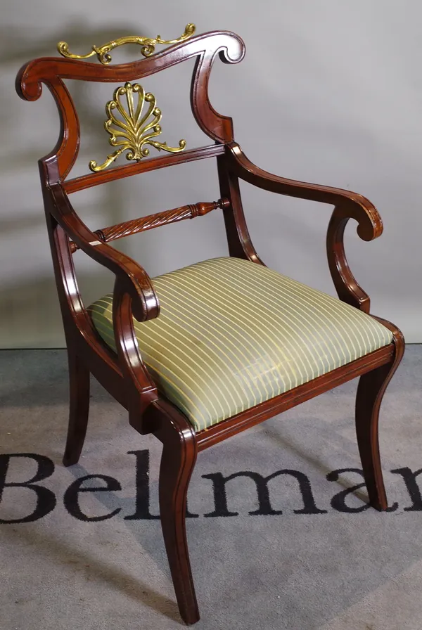 A Regency style mahogany open armchair with gilt metal back on sabre supports 55cm wide x 90cm high and a 20th century rectangular footstool of taperi