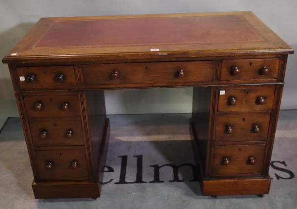 A late 19th century oak pedestal desk with nine drawers and red leather inset top, 108cm wide x 73cm high.