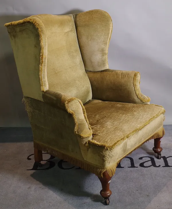 A Queen Anne style mahogany framed wingback armchair, on tapering pad feet, 80cm wide x 107cm high.