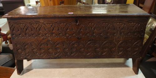 A 17th century and later oak coffer with carved front feet, 104cm wide x 51cm high.