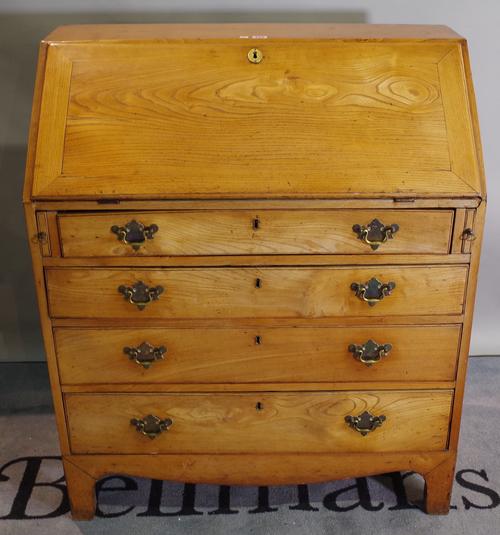 An early 20th century oak and elm fronted bureau with four ong graduated drawers.