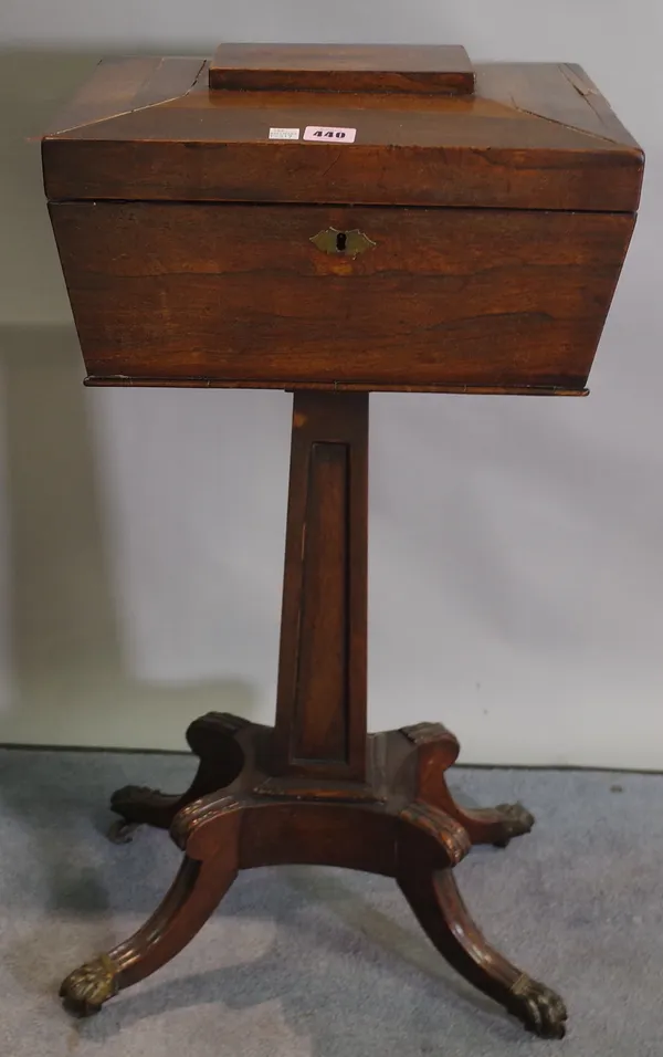 A George III style rosewood teapoy on tapering column and four outswept supports, 37cm wide x 76cm high.