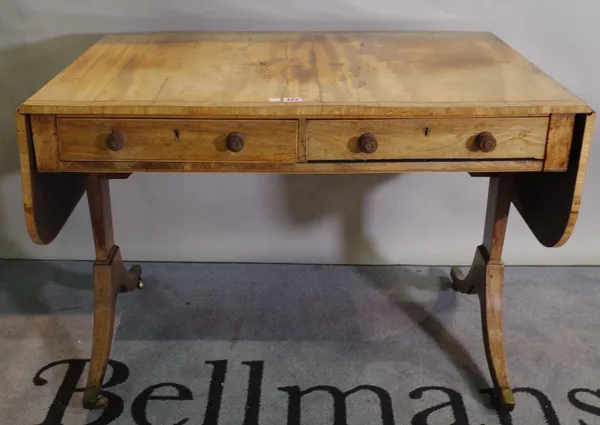 A Regency mahogany sofa table with two drawers on duel ended supports.