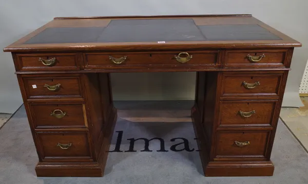 A late 19th century oak pedestal desk, with nine drawers about the knee, 130cm wide x 73cm high.