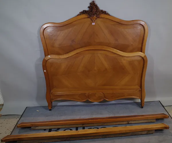 An early 20th century French walnut arch back double bed, 144cm wide x 151cm high.