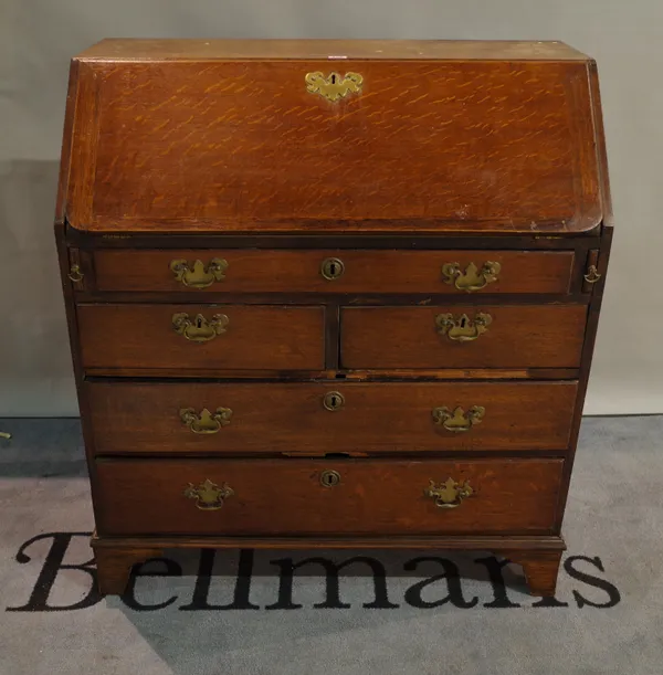 A late George III oak bureau of two short and three long drawers on bracket feet 91cm wide x 103cm, high.