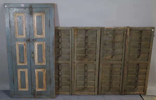 A 20th century blue painted window shutter with later added mirror 62cm wide x 122cm high and an early 20th century set of four wall hanging window sh