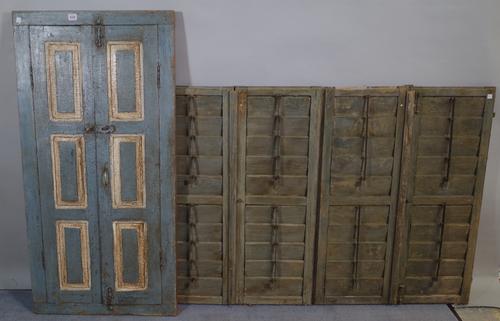 A 20th century blue painted window shutter with later added mirror 62cm wide x 122cm high and an early 20th century set of four wall hanging window sh