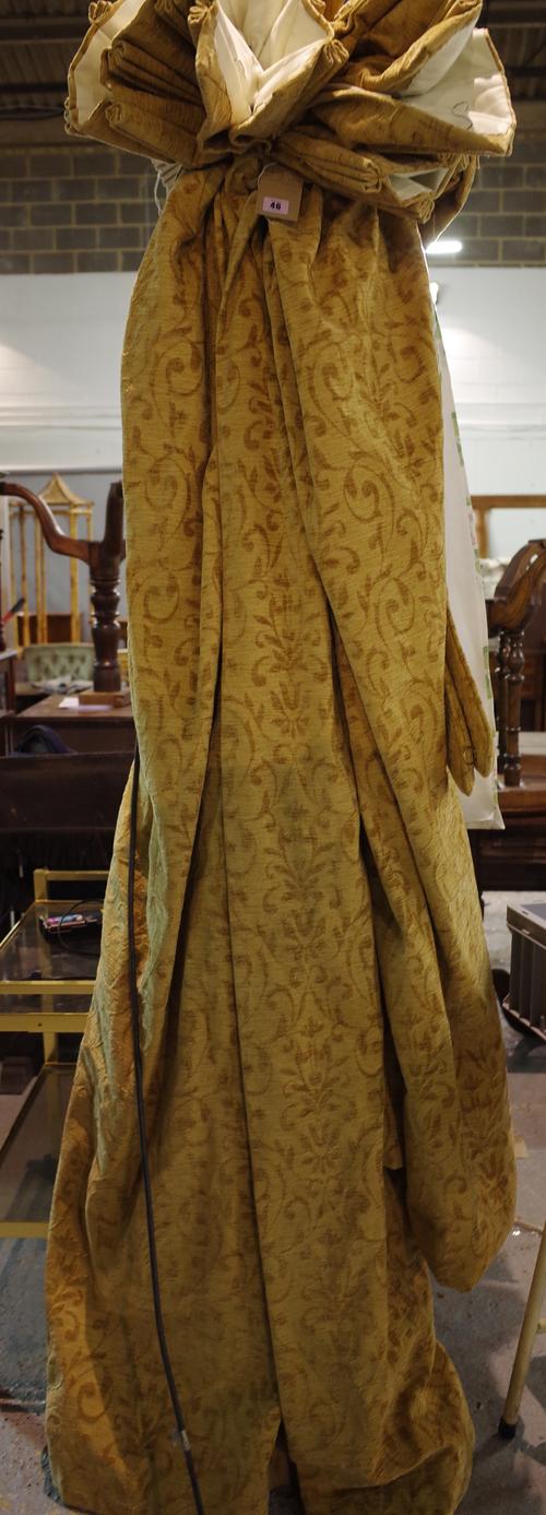 A near pair of lined and interlined gold foliate curtains, one 135cm wide x 180cm drop, the other 140cm wide x 200cm drop.
