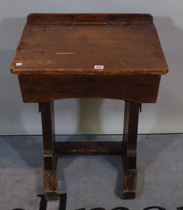 An early 20th century stained pine child's school desk, 55cm wide x 75cm high and a 20th century white painted hanging cupboard with single drawer, 30