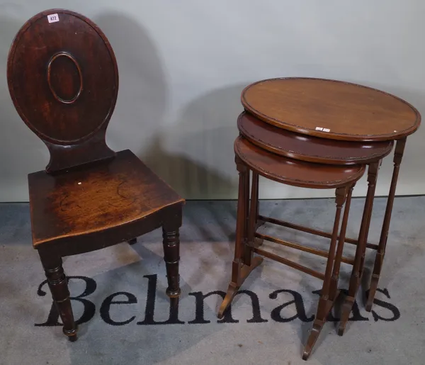 A Victorian mahogany hall chair, 46cm wide x 94cm high and a Victorian mahogany oval nest of three tables, the largest 56cm wide x 67cm high, (4).