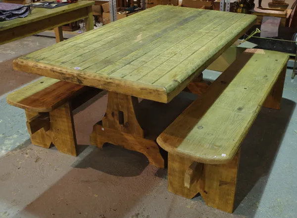 A 20th century pine kitchen table on lyre supports united by a stretcher, 102cm wide x 184cm long and two matching benches, 177cm long x 47cm high.