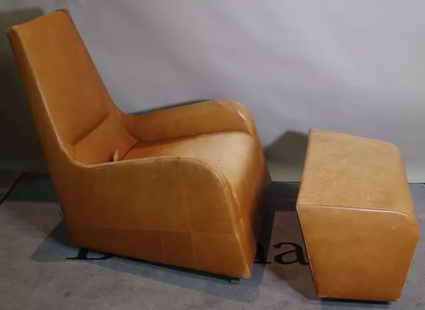 'LIGNE ROSET, Made in France' A 20th century low armchair and matching footstool with tan leather upholstery on folding metal supports, 68cm wide x 88