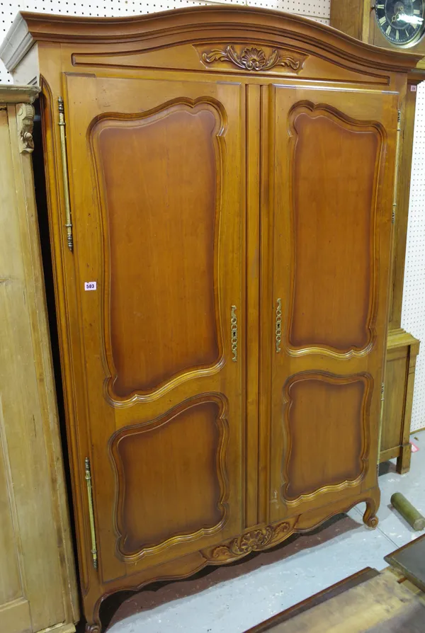 A 20th century walnut Continental style two door wardrobe on cabriole supports, 123cm wide x 194cm high.