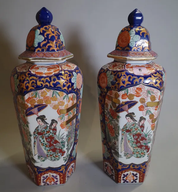 A pair of 20th century Imari style vases and cover of tapering octagonal form, 46cm high, (2).