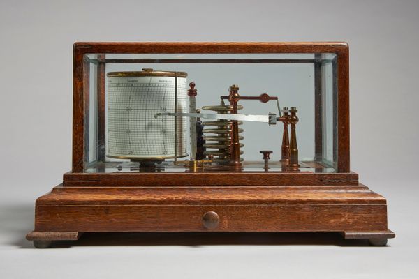 An oak cased barograph By Negretti & Zambra, LondonThe rectangular case with bevelled glass panels, the saffron lacquered brass platform with eight ch