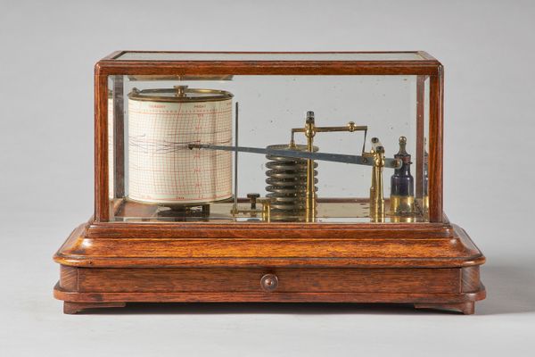 An Edwardian oak cased barographSigned Pillischer, London, circa 1900The case with bevelled glass plates and brass platform with eight aneroid chamber