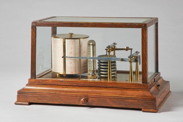 An Edwardian oak cased barograph Signed Turnbull & Co., EdinburghWith bevelled glass panel to the top, the brass frame with a silvered thermometer sca