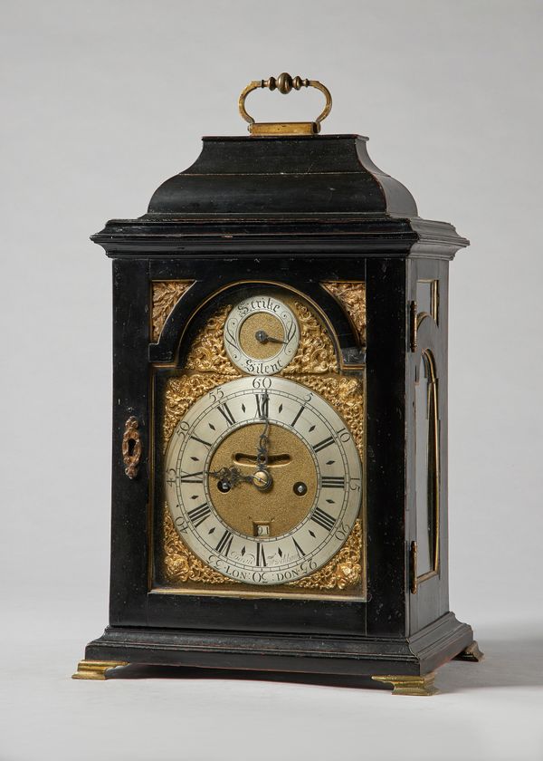 A George II gilt brass-mounted bracket clockBy David Fitzschkaw, LondonThe bell-top case with a brass carrying handle, above a moulded pediment, with