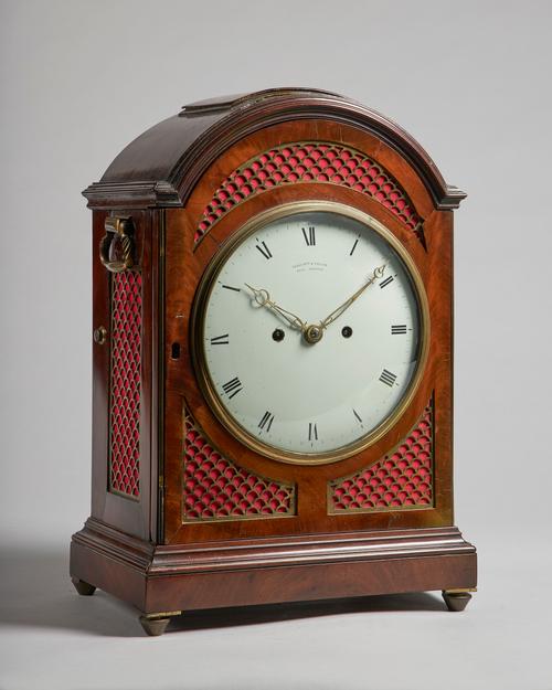 A Regency mahogany bracket clockBy Ellicott & Taylor, London, circa 1820The arched case with a pad top, above grille sides and two carrying handles, t