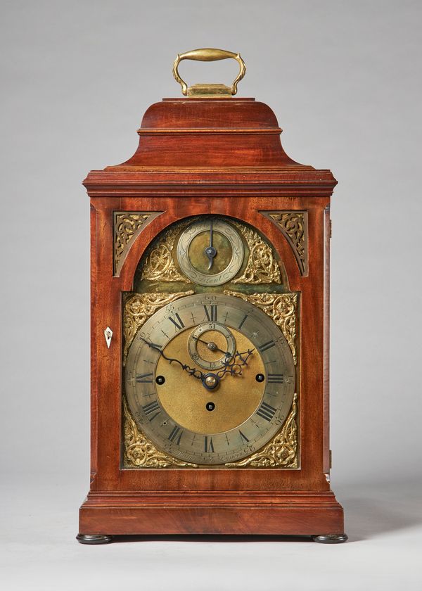 A mahogany cased three train quarter chiming bracket clockThe bell-top case with a brass carrying handle, above a moulded pediment with glazed panel d