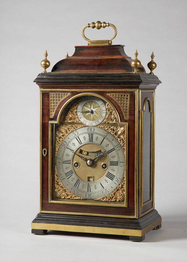 A George I brass-mounted fruitwood striking table clock with pull-quarter repeatBy Simon de Charmes, LondonTh bell-top case surmounted by a knopped br