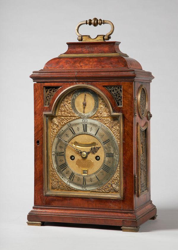 A George I giltmetal-mounted walnut striking quarter repeating table clockBy Charles Goode, London, circa 1715The case with a bell top surmounted by a