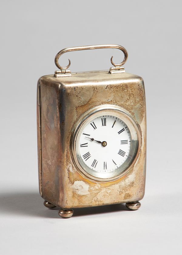 A silver cased carriage timepieceBirmingham, 1901The rounded rectangular case with scrolled handle, with 1 3/4in. circular white enamel dial, the move