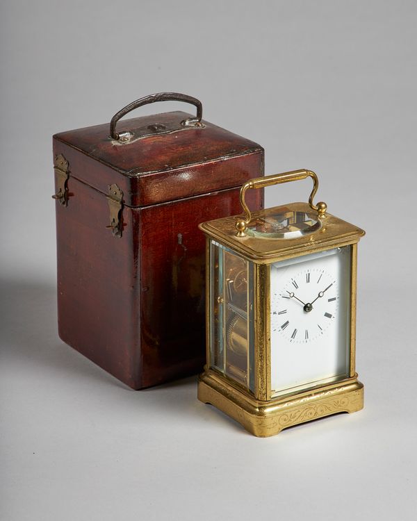 A French brass carriage clockBy Japy Freres, circa 1860The gilt brass Corniche case with scrolled engraving, white enamel dial and Breguet blued steel