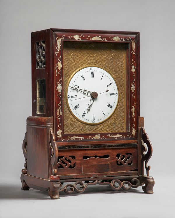 A Chinese hardwood and mother-of-pearl inlaid table clock19th centuryThe case with a glazed lift-up front cover and pierced back cover, glazed sides,t