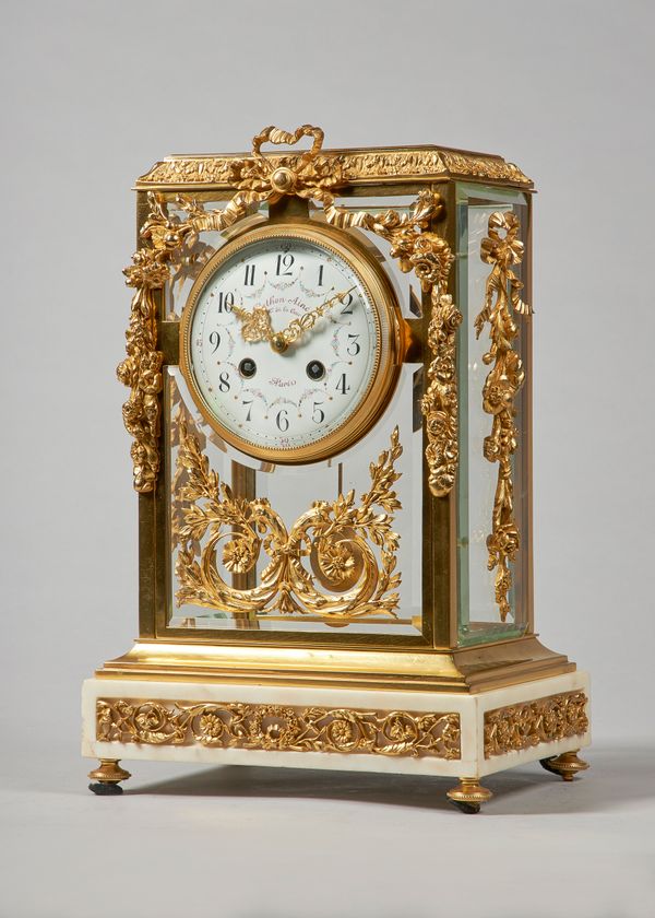 A French ormolu and white marble four glass mantel clockIn the Louis XVI style, circa 1900Th rectangular top with a leaf and berried cast edge, above