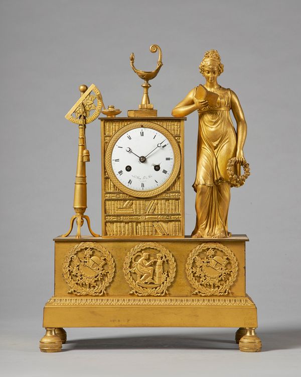 An Empire ormolu mantel clockSigned Le Roy, ParisModelled with a standing female figure reading, a wreath in her hand, surmounted by an oil lamp and f