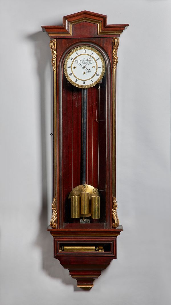 A Viennese parcel-gilt mahogany three-train quarter chiming regulator with music boxBy Joseph Rammel, Vienna, circa 1850The case with an arched pedime