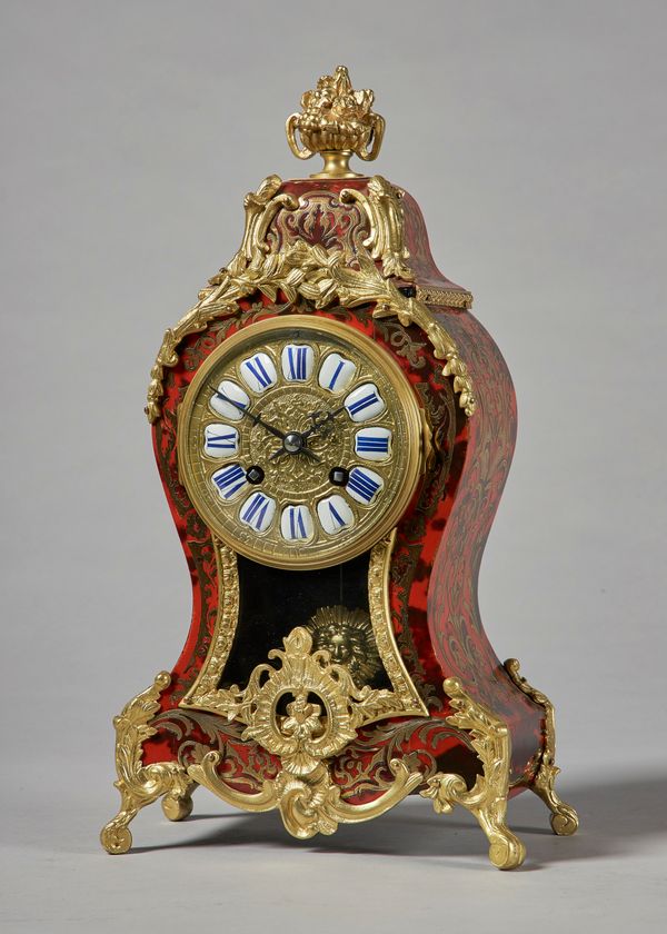 A French giltmetal-mounted, tortoiseshell and cut brass-inlaid mantel clockIn the Louis XV style, circa 1900The case of waisted form, surmounted by a