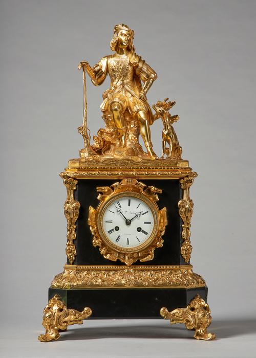 A French giltmetal and black marble mantel clockCirca 1860Modelled with a seated figure of a hunter on a rocky outcrop, holding a long gun, a seated h