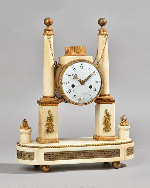 A FRENCH GILTMETAL-MOUNTED MARBLE MANTEL CLOCK  Early 19th century and later    Modelled with a drum-shaped case, supported between a pair of tapered
