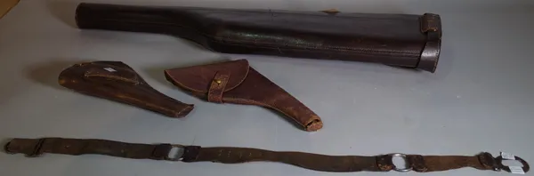 An early 20th century shotgun leather case, 79.5cm long , two leather pistol holsters and a leather scouts belt, (4).