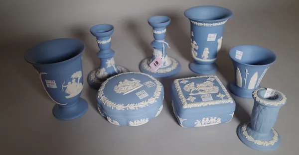 A group of Wedgwood blue jasper, 20th century, mostly sprigged with classical figures, comprising; a pair of candlesticks, 123cm high, a small candles