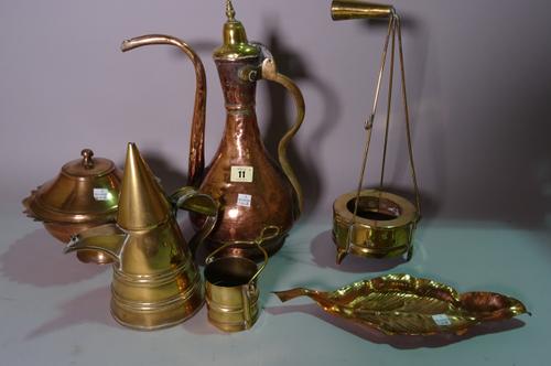 A group of copper and brass including a Turkish ewer, lidded pots, a leaf shaped dish and sundry decorative items.