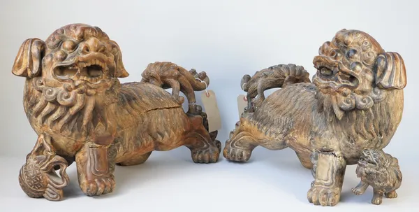 A pair of modern hardwood carved Chinese Buddhistic dogs of Fo, 60cm wide, (2).