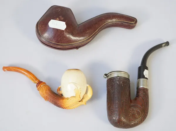 A Meerschaum pipe, early 20th century, carved with eagles claw clutching an egg form bowl, cased, and a hardwood carved pipe detailed 'Pretoria Boer W